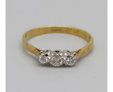 An 18ct gold, three stone diamond ring, 2.1g, M 