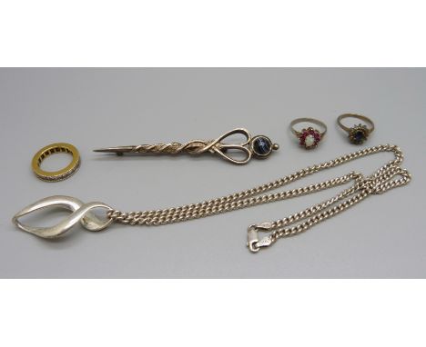 A Scottish silver brooch set with a stone, a silver chain, a white metal pendant, two silver cluster rings including one set 