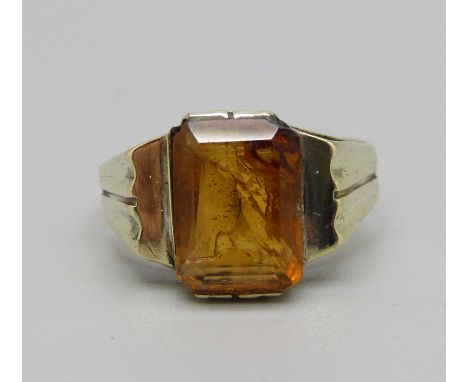 A yellow metal ring set with amber coloured stone, marked 585, 4.6g, Q 