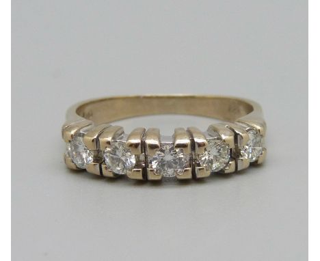 A five stone diamond ring, approximately 0.65 carat weight, marked 750 and 18ct, 5.9g, R 