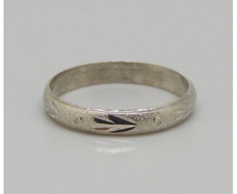 A white metal ring, stamped 18k, 1g, M 