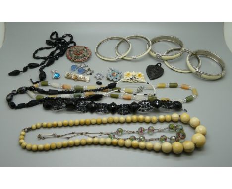 A bag of costume jewellery including silver pendants and a jade and onyx necklace 