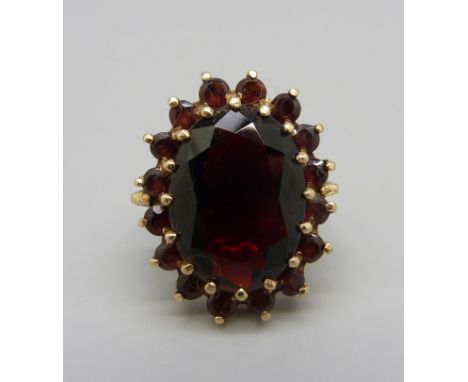 A yellow metal and garnet cluster ring, 7.3g, O, top approximately 20mm x 23mm 
