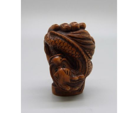 A netsuke, hand with dragon 