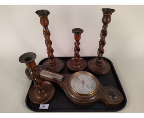 Two pairs of barley twist oak candlesticks with brass sconces, tallest 12 1/2" plus an oak cased barometer