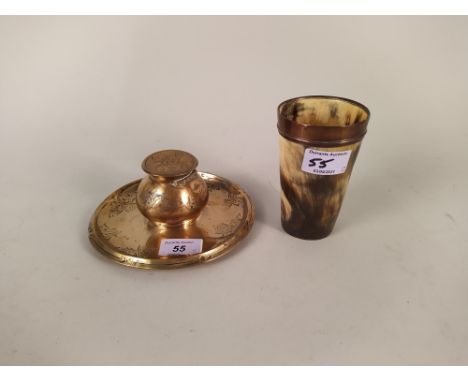 An engraved circular brass inkwell and stand plus a copper rimmed horn beaker