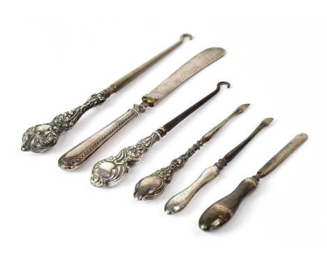 A group of hallmarked silver handled items, comprising two button hooks, three manicure tools and a butter knife (6).