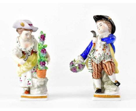 SITZENDORF; a pair of porcelain gardener figures, each holding a small scythe and cutting grapes, printed marks, maximum heig