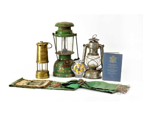 A collectors' lot, comprising a brass miners' lamp inscribed 'British Coal Mining Company, Wales', two other miners' lamps, a