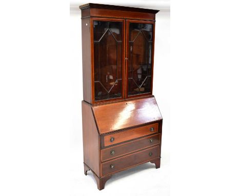 An Edwardian mahogany crossbanded and line inlaid bureau bookcase, the upper section with pair of astragal glazed doors enclo