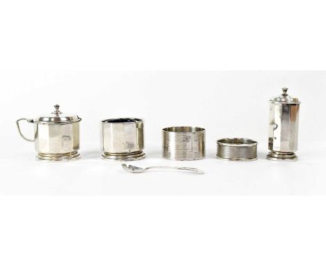 HUKIN &amp; HEATH; a George V hallmarked silver faceted cruet set, comprising a pepperette, height 7.5cm, a lidded mustard wi