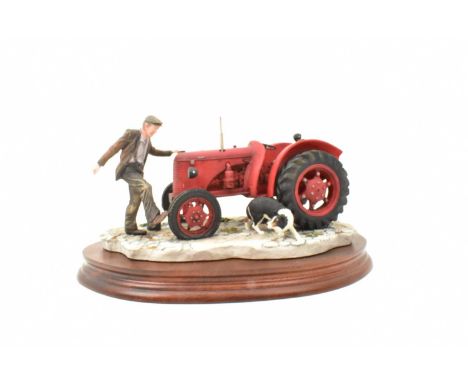 BORDER FINE ARTS; a tractor figure group, 'Kick Start', model no. B0541, a red tractor with dog, on wooden plinth, length 22c