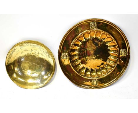 A large brass charger, with hammered effect centre and shell border within a wider border with a bird at each quarter and a r