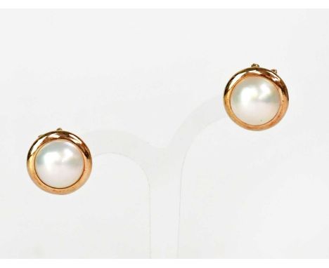 A pair of half Mabé pearl earrings in 14ct yellow gold mounts, with stud and clip backs.  Condition Report: Each stamped '14K