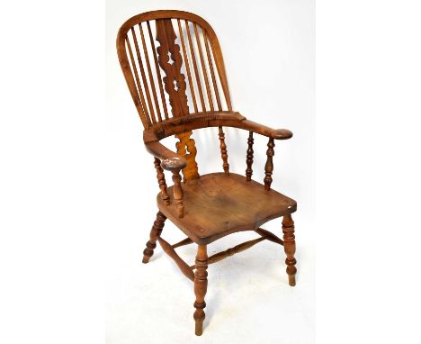 A 19th century Provincial Windsor stick back armchair, with outswept arms, bobbin turned columns, shaped solid seat, double s