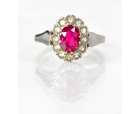 A 9ct yellow gold ring set with an oval pink stone surrounded by diamonds, size K, approx. 2.2g.Condition Report: - Stamped '