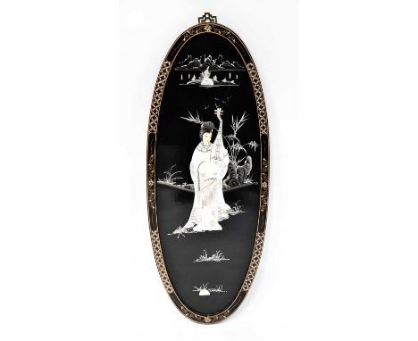 A Chinese oval lacquered wall panel inlaid with mother-of-pearl, depicting a female musician in a landscape, 91 x 36cm.Condit