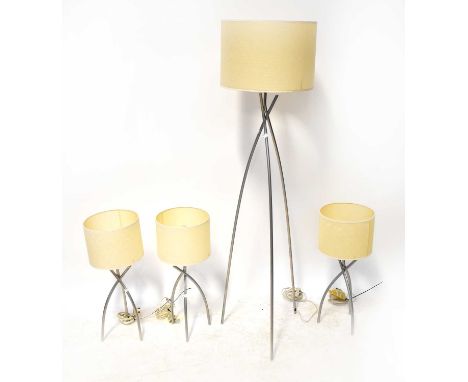 Three table lamps with tripod tubular metal bases, height of each including shades 61cm, and a matching standard lamp, height