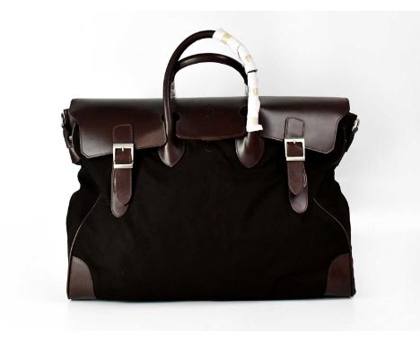 PATEK PHILIPPE; a brown leather and canvas overnight bag, with outer dust bag, and shoulder strap, approx. 39 x 55 x 160cm.Co