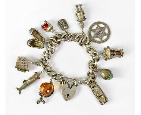 A hallmarked silver charm bracelet with a heart-shaped clasp and safety chain, set with white metal charms, including a car, 