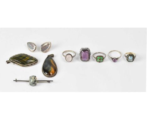 A group of silver and white metal jewellery, comprising a 9ct yellow gold and silver ring set with a pale blue stone surround