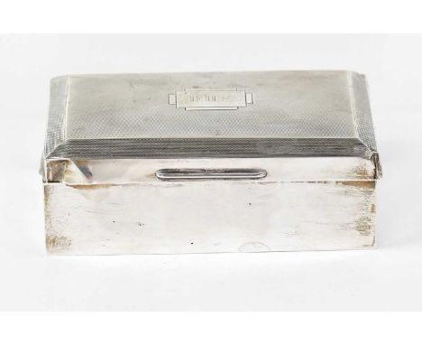 A George VI hallmarked silver cigarette box, with engine turned decoration to the lid and rectangular cartouche with initials