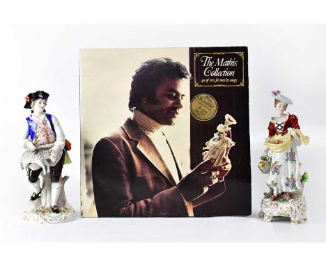 SITZENDORF; a porcelain figure of a lady carrying flowers in her apron in one hand and a watering can in the other, on a Roco