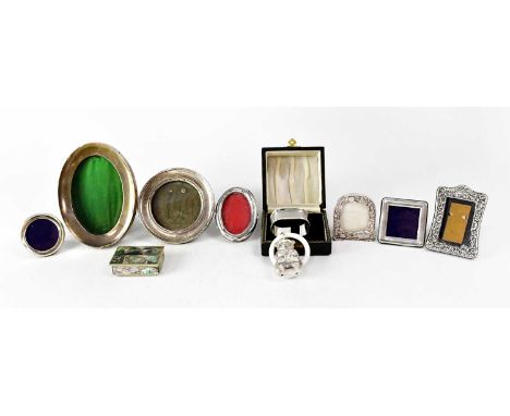 A cased hallmarked silver napkin ring with engine turned decoration and initialled cartouche, four hallmarked silver photogra