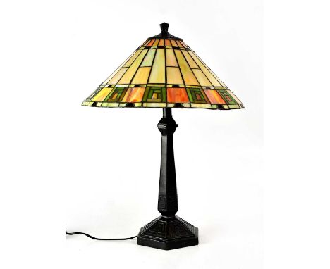 A Tiffany-style table lamp with iridescent stained-glass shade, on black resin column, height 60cm.Condition Report: - This l