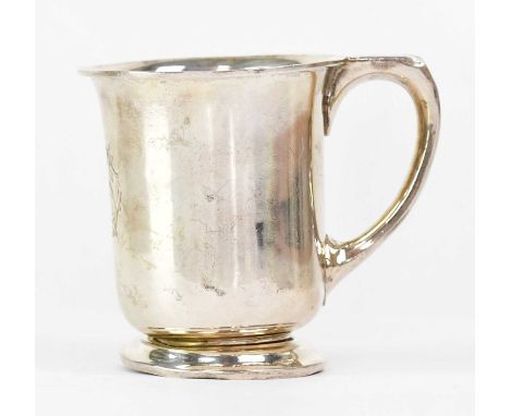 A George V hallmarked silver small mug to footed base, inscribed to the front with entwined letters 'DHS', maker's marks rubb