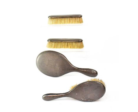 MAPPIN &amp; WEBB; a Victorian hallmarked silver dressing table set, comprising a hand mirror, a hairbrush and two clothes br