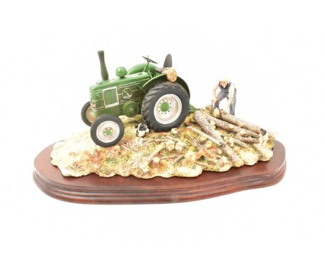 BORDER FINE ARTS; a tractor figure group, 'Hauling Out', model no. JH98, a green tractor with logs, on wooden plinth, length 