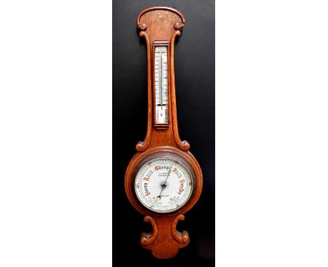 F. J. READ, MANNINGHAM LANE, BRADFORD; an early 20th century oak aneroid barometer, with ivorine dial and thermometer above, 