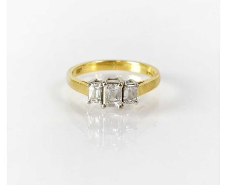 An 18ct gold ring set with three baguette cut diamonds in white gold claw setting, marked '750', size K, approx. 3.4g.Conditi