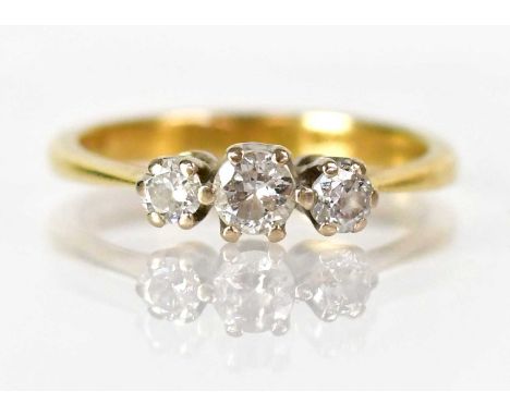 An 18ct yellow gold ring set with three diamonds, size K, approx. 2.4g.Condition Report: - Stamped '750' to the shank interio