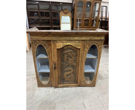A beechwood cupboard enclosed by a carved panel door flanked by oval bevelled glass plates. 42'w x 40'h