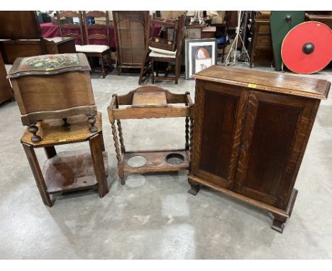 An oak cabinet; an oak stick stand; a step commode and an oak two tier table (4)