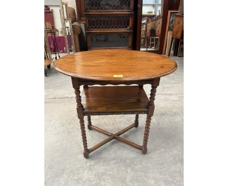 An oak oval two-tier centre table on bobbin turned legs. 26' wide