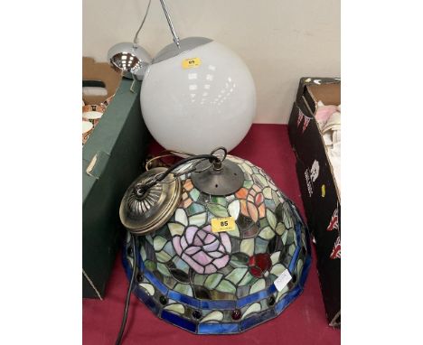 A Tiffany style hanging lamp and a globe lamp