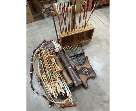 A large quantity of arrows, two arrow stands and three archer's bows 