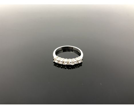 A platinum &amp; diamond seven-stone half eternity ring, size K. 