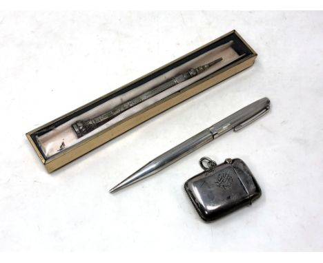 A silver pencil, pen, a silver vesta case