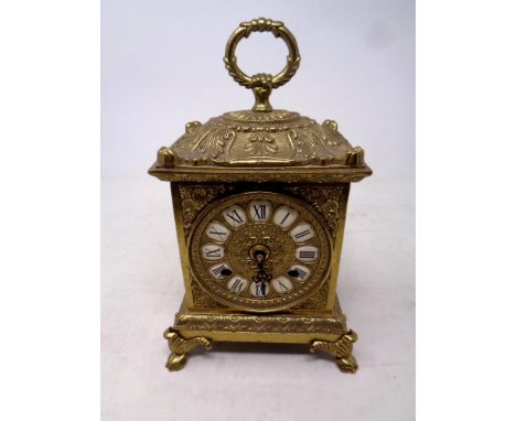 A decorative German gilt metal carriage clock on raised feet 