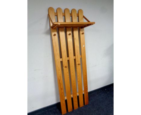 A pine wall mounted coat rack with shelf 