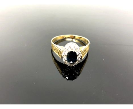 A yellow gold diamond and sapphire cluster ring, size S/T, 4.7g. CONDITION REPORT: Hallmarked rubbed, estimated as 18ct.