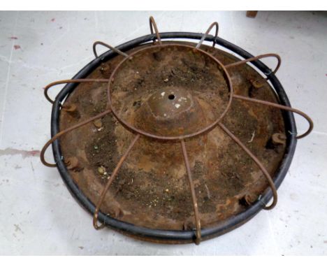 A circular cast iron pig feeding trough