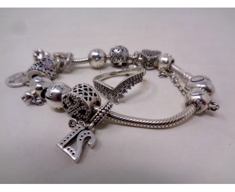 A Pandora charm bracelet together with a lady's silver ring 