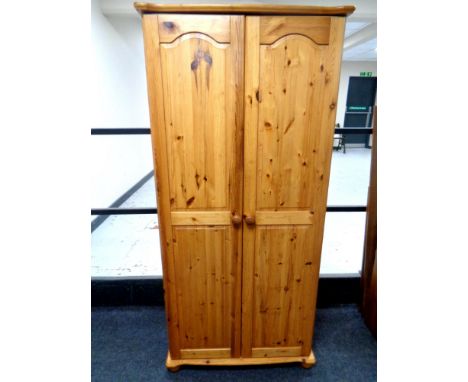 A contemporary pine double door wardrobe 