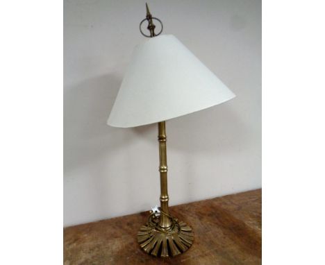 A brass table lamp with shade, height 76 cm.