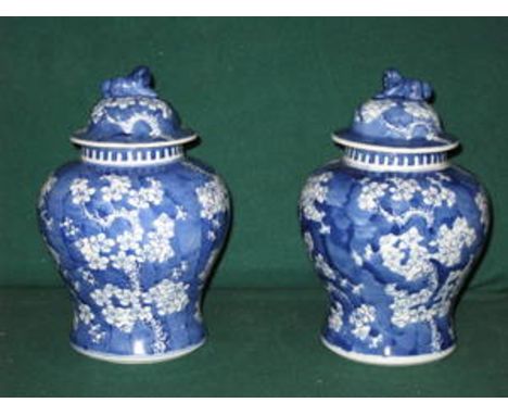 PAIR OF BLUE AND WHITE ORIENTAL STYLE GLAZED CERAMIC STORAGE JARS WITH COVERS, APPROXIMATELY 27cm HIGH 